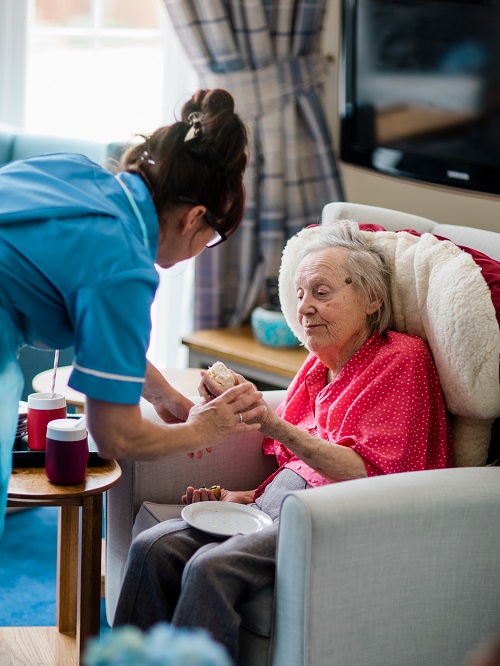 Dementia Care Homes - supporting resident with her meal